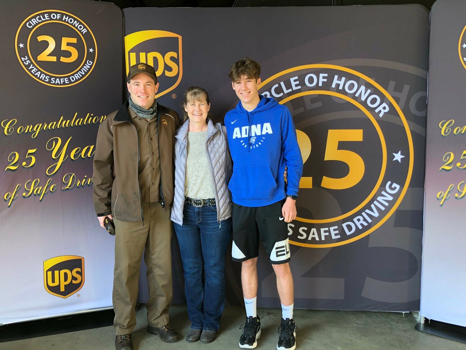 Kevin Aselton stands with his wife, Juli, and son, Aaron, in 2021 after being inducted into the UPS Ring of Honor, which recognizes drivers with a safe driving record. Aselton has two daughters not pictured, Kelsey and Peyton.